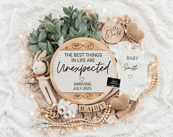 May include: A wooden sign with the text "The best things in life are unexpected" and "Arriving July 2025". The sign is surrounded by a white baby onesie with the text "Baby Smith", a stuffed bunny, wooden blocks that spell "baby", and other baby-themed decorations.