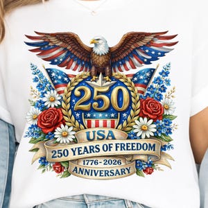 May include: White t-shirt featuring a patriotic design for the 250th anniversary of the USA. The graphic includes a bald eagle with outstretched wings, the number 250, flags, flowers, and the text "250 Years of Freedom 1776-2026 Anniversary".