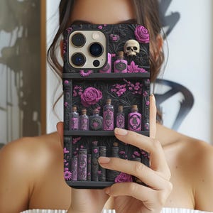 May include: A black phone case featuring a gothic-themed design. The case depicts a miniature bookshelf with potion bottles, roses, and a skull. The bottles are pink and the roses are a vibrant magenta color.