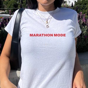 Marathon Mode, Y2K Baby Tee, Race Preparation, Endurance Focus Tee, Distance Runner, Athletic Commitment, Runner Life Graphic, Endurance
