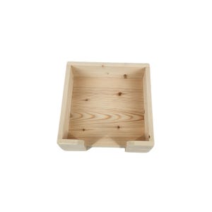 May include: A wooden box with a square shape and an open top. The box is made of light-colored wood and has a smooth finish.