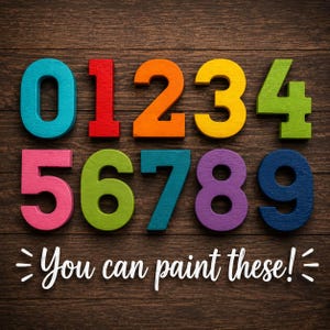 May include: A set of ten wooden numbers from zero to nine, each in a different vibrant color including teal, red, orange, yellow, lime green, pink, olive green, blue, purple, and navy. The text "You can paint these!" is printed below.