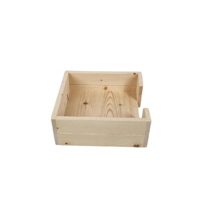 May include: A natural wood square tissue box holder with a simple design. The holder has a slot on the side for easy access to tissues.
