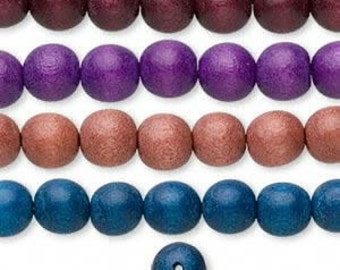 May include: A strand of wooden beads in four colors: burgundy, purple, rose gold, and teal. The beads are round and have a smooth, matte finish.