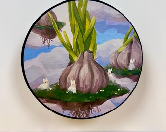 May include: A circular painting featuring large, purple-toned garlic bulbs with green shoots growing on floating islands. Small white rabbits are nestled in the green grass at the base of the bulbs against a backdrop of blue sky and white clouds.