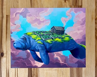 May include: A rectangular art print featuring a blue manatee floating through a sky of pink and blue clouds. On the back of the manatee is a small log cabin surrounded by several raised garden beds filled with green plants and mossy patches.