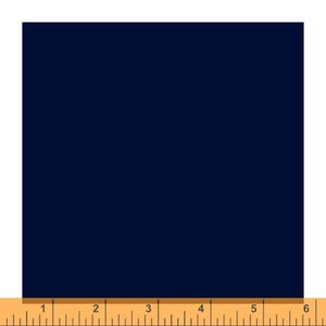 May include: A square of navy blue fabric, with a ruler along the bottom edge. The ruler shows measurements in inches, with markings from 1 to 6 inches.