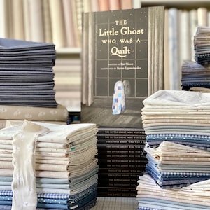 May include: A stack of folded fabric in shades of blue, cream, and white, featuring a book titled The Little Ghost Who Was A Quilt by Riel Nason and illustrated by Byron Eggenschwiler, with a ghost character on the cover wearing a blue and white quilt.