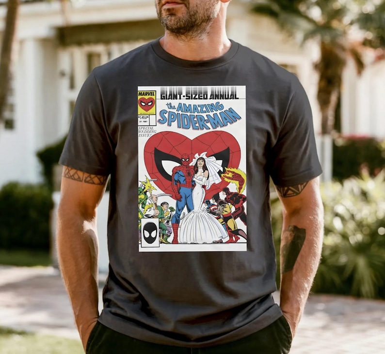 A man wearing a black t-shirt with a graphic of a comic book cover featuring Spider-Man and a bride.