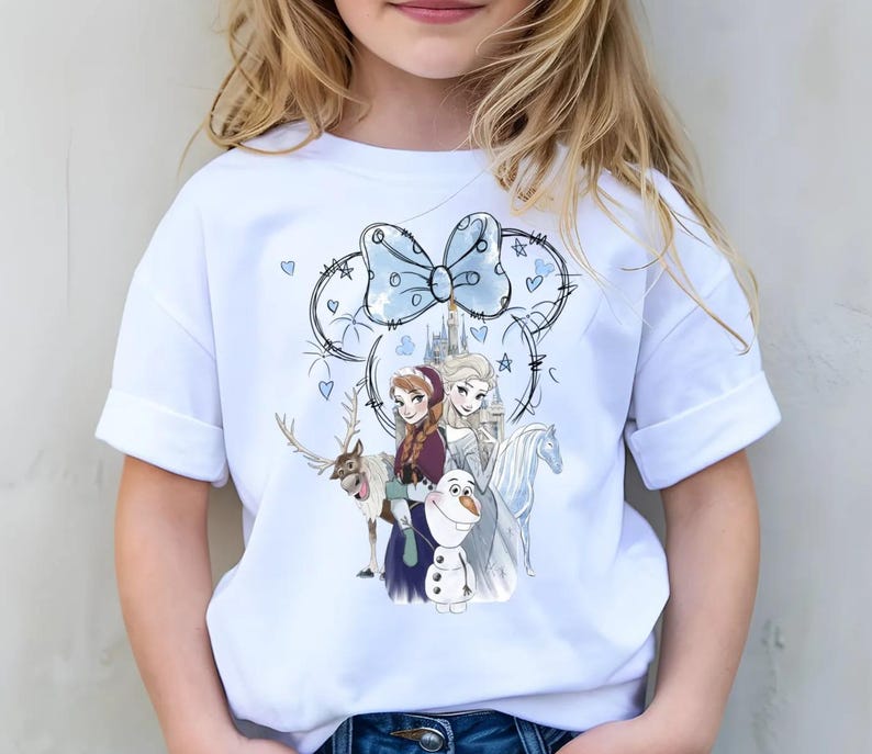 A young girl wearing a white t-shirt with a graphic of characters from the Disney movie Frozen.