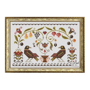 May include: Cross stitch pattern featuring two black birds perched on a branch with a heart, fruit, and flowers. The pattern is framed in a gold frame with the text "In Mood Stitching" in the bottom right corner.