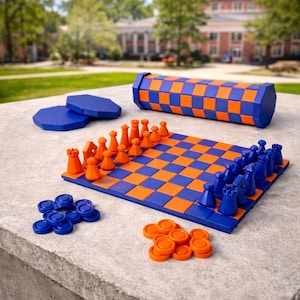 May include: A blue and orange chess and checkers set. The chess board and storage tube feature a checkerboard pattern. Chess pieces are orange and blue. Checkers pieces are orange and blue. Two blue octagonal pieces are also included.