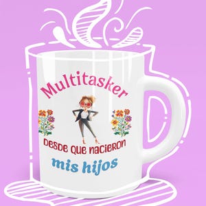 May include: White ceramic mug with a colorful illustration of a woman wearing sunglasses and a black outfit. The text "Multitasker desde que nacieron mis hijos" is printed on the mug.