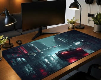 May include: A rectangular desk mat featuring a nighttime cityscape with a red sports car. The mat has a dark, moody color palette with neon lights and reflections on the wet pavement. The mat is designed to protect the desk surface.