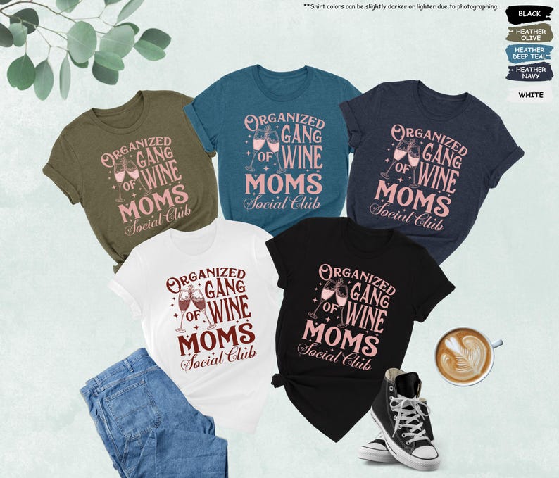 May include: Five t-shirts in various colors, including black, white, and olive green, are displayed. Each shirt features the text "Organized Gang of Wine Moms Social Club" in a pink and brown design, with wine glasses. A pair of jeans, a cup of coffee, and a pair of sneakers are also visible.