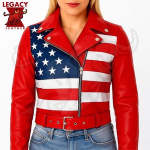 May include: A red leather jacket with a design of the American flag on the left side and back. The jacket has a zipper closure, a belt, and a collar. The sleeves and the rest of the jacket are red. The Legacy Leather logo is in the upper left corner.