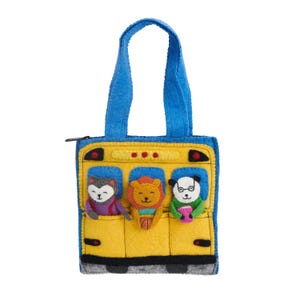 May include: A yellow felt tote bag shaped like a school bus with blue handles and a zipper closure. The front features three embroidered animal characters: a gray cat, an orange lion, and a white panda wearing glasses, all peeking out of windows.