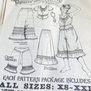 May include: A vintage clothing pattern sheet featuring line drawings of a ruffled top, ankle-length pants, a skirt, and a pair of frillies. The illustration shows a person wearing the set while holding a mirror. Text includes Authentic Vintage Clothing Patterns, ankle length version, Open version, Frillies, and ALL SIZES: XS-XXL.