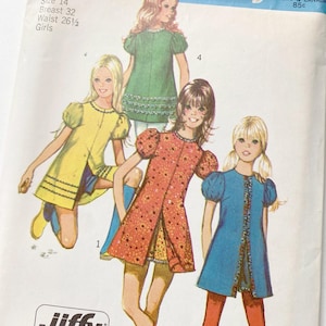 May include: Vintage sewing pattern featuring illustrations of girls' dresses. The pattern includes designs for dresses in yellow, green, orange, and blue, with details like puff sleeves and decorative trim. The text on the pattern reads "Size 14, Breast 32, Waist 26 1/2, Girls."