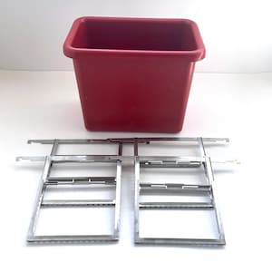 May include: A rectangular red plastic bin paired with two metallic hanging file frames. The frames feature horizontal bars with notched ends designed for suspension, while the bin has a wide, open top and smooth, solid walls for storage.
