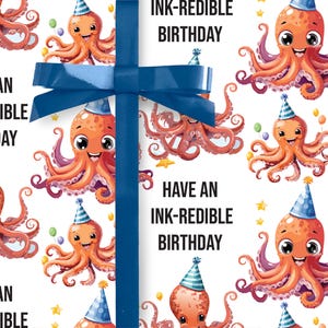 May include: White wrapping paper featuring a pattern of orange cartoon octopuses in party hats. Text reads "INK-REDIBLE BIRTHDAY". A blue ribbon is tied around the paper, suitable for a birthday gift.