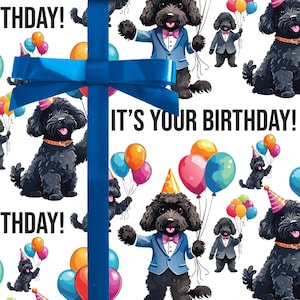 May include: White wrapping paper featuring a repeating pattern of black cartoon dogs with balloons, party hats, and suits. The text "IT'S YOUR BIRTHDAY!" is displayed in black. A blue ribbon and bow are in the foreground.