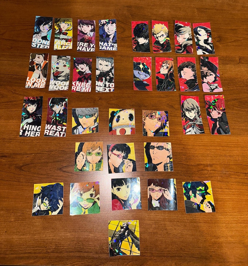 May include: A set of 20 holographic stickers featuring characters from the Persona 5 video game. The stickers are rectangular and square in shape and feature various characters from the game, including the protagonist, Joker, and his confidants. The stickers are printed on a clear background with a holographic finish.