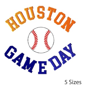 May include: White background with the words "HOUSTON GAME DAY" in orange and blue embroidery. A baseball with red stitching is in the center. The text "5 Sizes" is at the bottom.