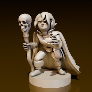 Puede incluir: Una pequeña figura de fantasía blanca de un mago sosteniendo un bastón con un cráneo en la parte superior. El mago lleva una capa y tiene orejas puntiagudas.