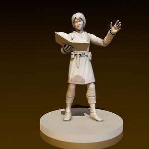 May include: A white figurine of a person holding a book and gesturing with their right hand. The figurine is standing on a round base.
