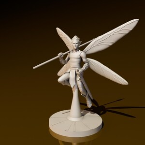 May include: A white fairy figurine with large, detailed wings, holding a staff. The fairy is posed dynamically on a round base. The figure is set against a gradient brown background.