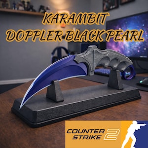 May include: A Karambit Doppler Black Pearl knife with a curved, blue blade and a grey handle, displayed on a black stand. The text "Karambit Doppler Black Pearl" is above the knife. The Counter Strike 2 logo is at the bottom.