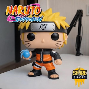 May include: A Funko Pop! vinyl figure of Naruto from Naruto Shippuden. The figure is wearing an orange and black outfit, a headband, and holding a blue energy ball. The figure has yellow spiky hair and large black eyes. The figure is standing on a white surface.