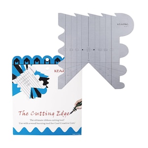 May include: A silver metal ribbon cutting tool with measurements in inches, and a white and blue package with the text "The Cutting Edge". The tool is designed for use with a wood burning tool.