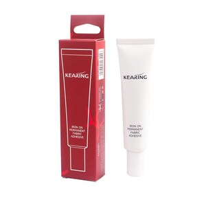 May include: A white tube of KEARING Iron On Permanent Fabric Adhesive with a red and white box behind it. The box has the brand name KEARING and the product description.