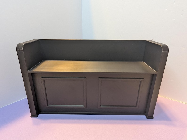May include: A dark brown wooden bench with a back and two front panels. The bench has a simple, classic design, suitable for indoor use. The bench is approximately 48 inches wide, 18 inches deep, and 36 inches high.