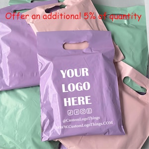 May include: A collection of pastel-colored plastic mailing bags with die-cut handles in lavender, light pink, and mint green. The central lavender bag features white text reading YOUR LOGO HERE, social media icons, @CustomLogoThings, and WWW.CustomLogoThings.COM.