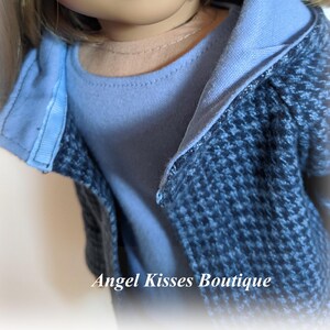May include: A blue and black patterned jacket with a blue hooded top. The jacket is worn over a light blue shirt.