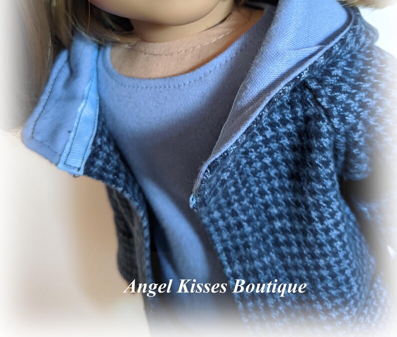 May include: A blue and black patterned jacket with a blue hooded top. The jacket is worn over a light blue shirt.