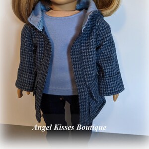 May include: A blue and white patterned coat with a blue denim collar and a light blue shirt underneath. The coat has a hood and pockets.  Angel Kisses Boutique is printed at the bottom of the image.