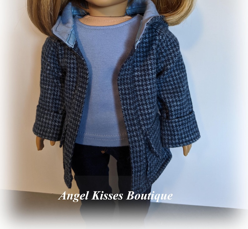 May include: A blue and white patterned coat with a blue denim collar and a light blue shirt underneath. The coat has a hood and pockets.  Angel Kisses Boutique is printed at the bottom of the image.