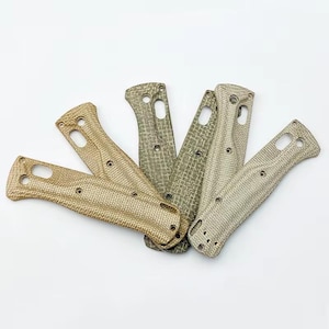 Könnte beinhalten: Sechs strukturierte Messergriffschalen in verschiedenen Beige- und Olivgrüntönen. Jede Schale hat ein gebogenes, ergonomisches Design mit vorgebohrten Löchern zur Befestigung. Die Schalen haben ein gewebtes Muster.