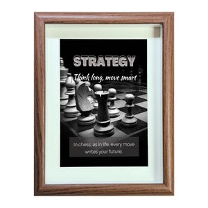 May include: A framed black and white photo of a chessboard with chess pieces. The photo has the text "STRATEGY Think long, move smart" and "In chess, as in life, every move writes your future."