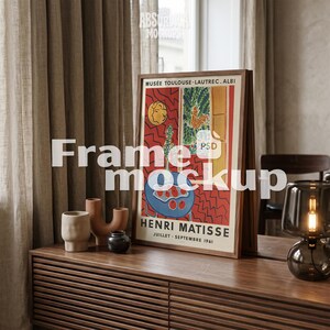 May include: A rectangular wooden frame containing a Henri Matisse exhibition poster from the Musée Toulouse-Lautrec Albi, dated Juillet-Septembre 1961. The poster features a colorful abstract interior scene with red, blue, and yellow tones.