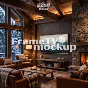 May include: A digital television screen mockup displaying a landscape painting, mounted on a dark wall above a wooden media console. The room features leather armchairs, a wooden coffee table, a stone fireplace, and large windows with snowy views.