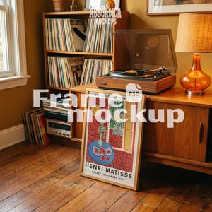 May include: A framed Henri Matisse exhibition poster featuring a red and yellow interior scene with a blue table and red fruit, resting on a wooden floor. The poster includes the text Musée Toulouse-Lautrec Albi and Henri Matisse Juillet-Septembre 1961.