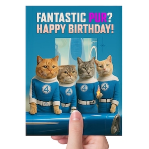 May include: A birthday card featuring four cats dressed in blue superhero uniforms with the number 4 on their chests. The card has the text "FANTASTIC PUR? HAPPY BIRTHDAY!" in pink and white against a blue background.