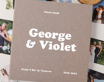 May include: A square, light brown fabric-covered guest book featuring white text that reads "Guest book", "George & Violet", "From 'I Do' to 'Forever'", and "Italy 2024" printed on the front cover in a clean, sans-serif and bold font style.