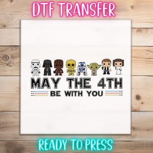 May include: White DTF transfer featuring Star Wars characters and the text "MAY THE 4TH BE WITH YOU." Includes images of Darth Vader, Yoda, and other iconic characters. The words "DTF TRANSFER" and "READY TO PRESS" are also displayed.