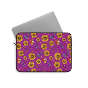 May include: A purple laptop sleeve featuring a floral pattern with yellow sunflowers, red and white butterflies, and green leaves. The sleeve has a black zipper and is designed to hold a laptop.